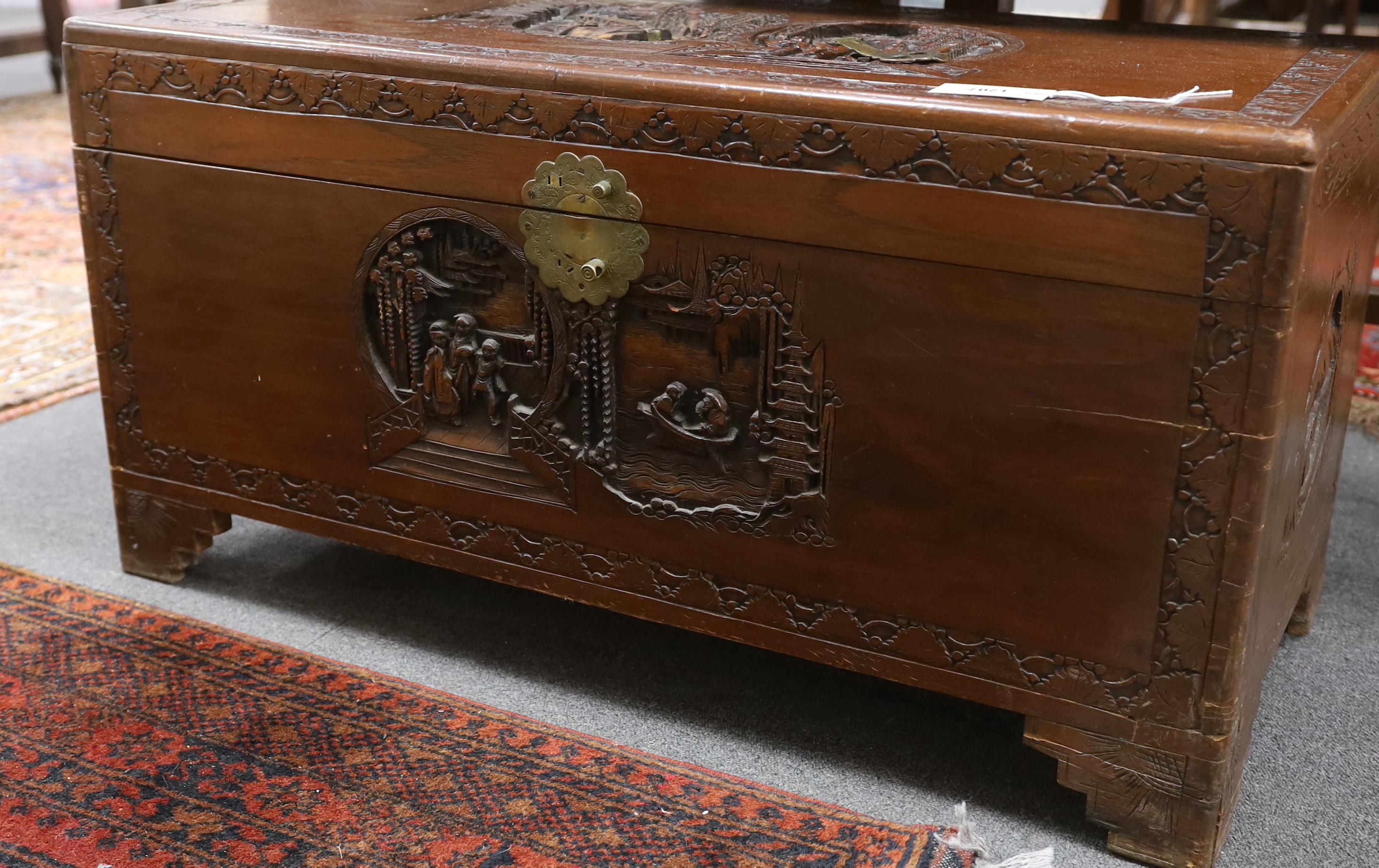 A Chinese carved camphor wood trunk, width 93cm, depth 44cm, height 48cm